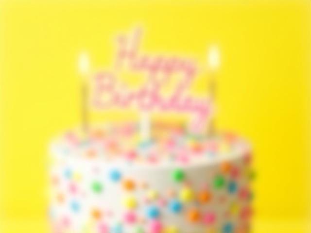 Vibrant, fun birthday cake with colorful sprinkles and candles.